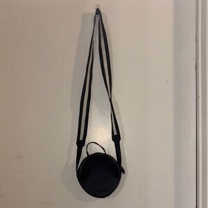 Black Round Crossbody Bag with Textured Design